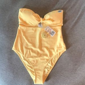 Pastel yellow strapless one piece with cutout